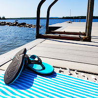 some blue sandals on a blanket overlooking a lake